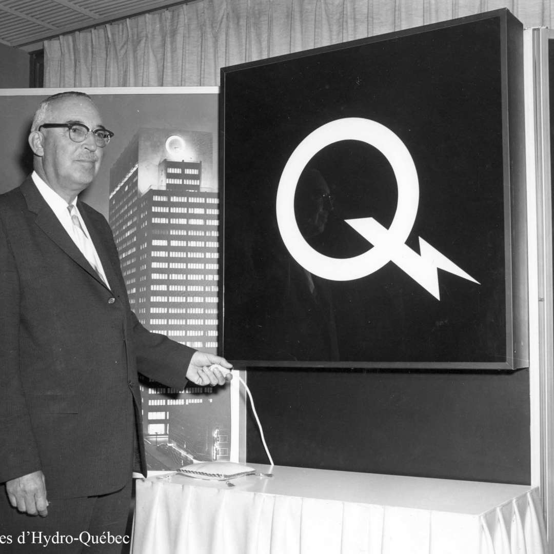 <p>Unveiling of the new logo—a symbol of a new era for the government corporation—by the president of Hydro-Québec, Jean-Claude Lessard, 1965. </p>
<p>©Hydro-Québec archives.</p>