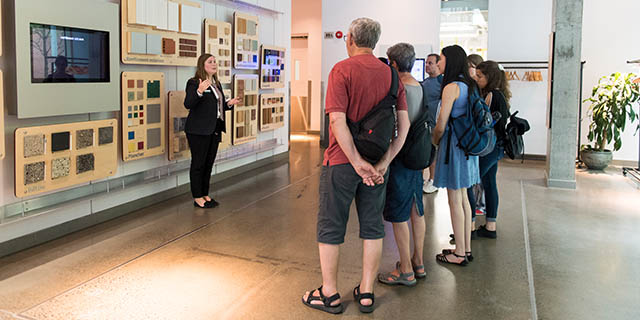 A tour guide and visitors in front of the material library.