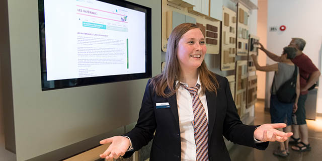 A tour guide in front of the material library.