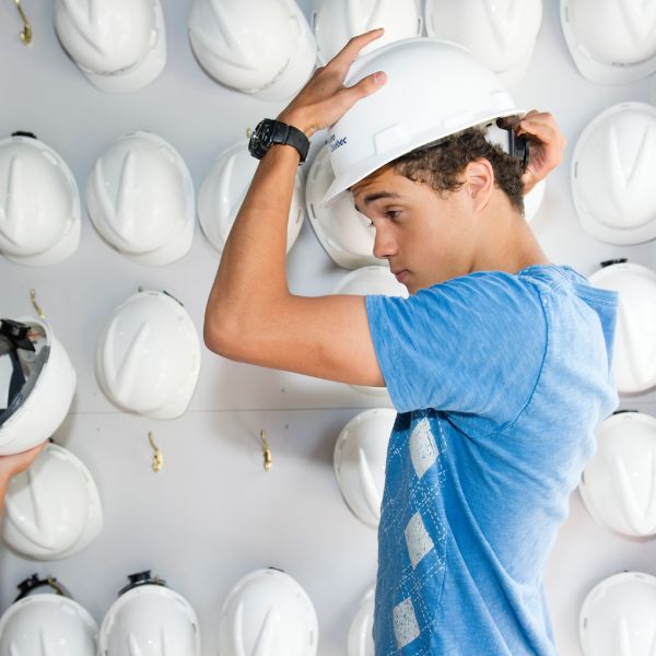 Visitor putting on a helmet.